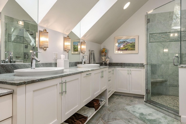 bathroom featuring a sink, vaulted ceiling, and a shower stall