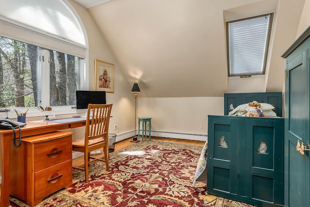 office area with baseboard heating, light wood-style flooring, and lofted ceiling