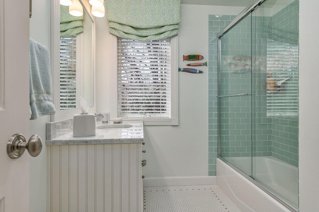 bathroom featuring vanity, bath / shower combo with glass door, tile patterned floors, and a healthy amount of sunlight