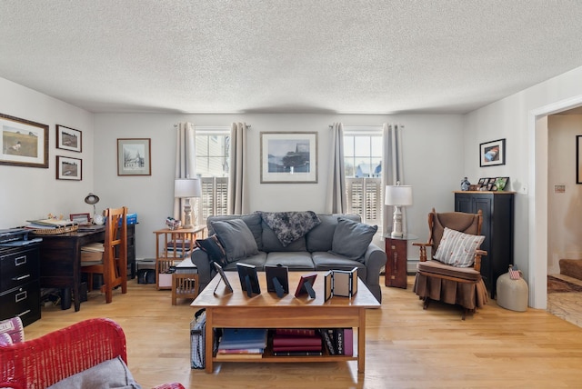living area featuring a textured ceiling and light wood finished floors