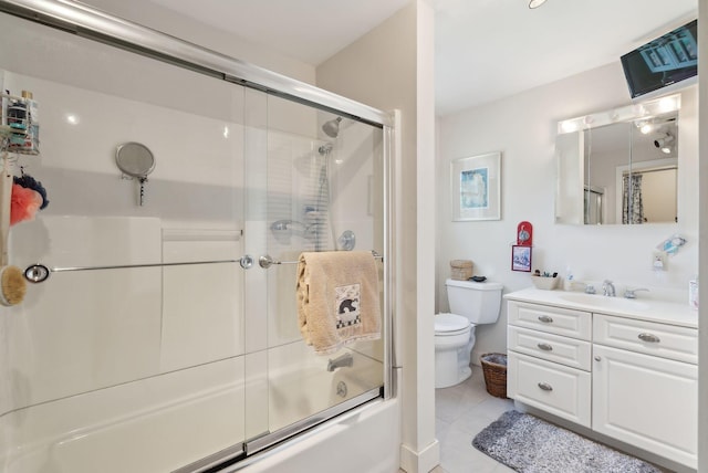 bathroom with toilet, bath / shower combo with glass door, tile patterned flooring, and vanity