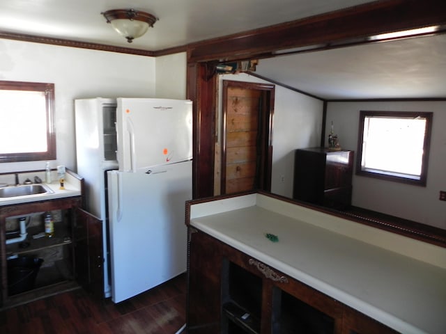 kitchen featuring freestanding refrigerator, dark wood-style flooring, and a sink