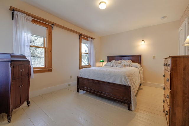 6 Sea St, Northeast Harbor, Mount Desert, ME 04662 - bedroom featuring multiple windows, baseboards, and light wood-type flooring