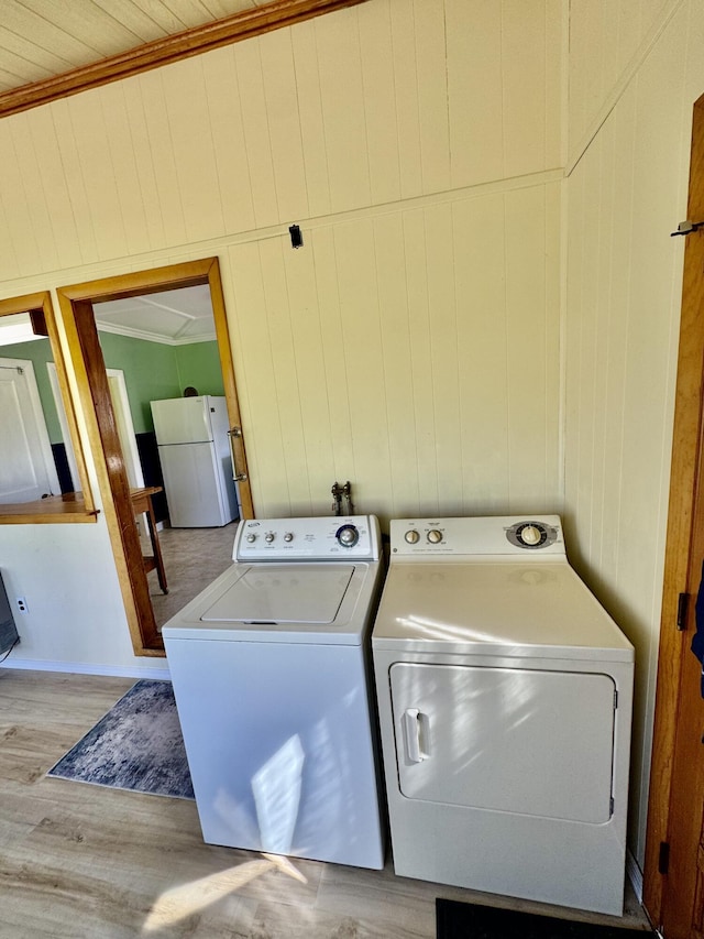 30 Mill St, Harrington, ME 04643 - laundry room with independent washer and dryer, light wood-style floors, wood walls, and ornamental molding