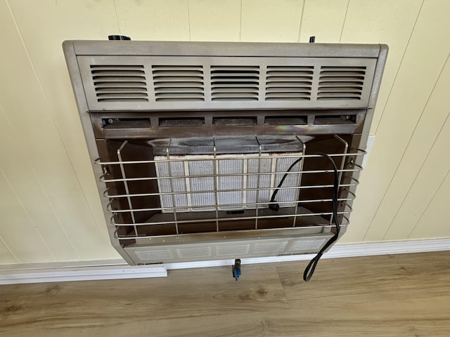 30 Mill St, Harrington, ME 04643 - detailed view of heating unit, wood finished floors, and baseboards