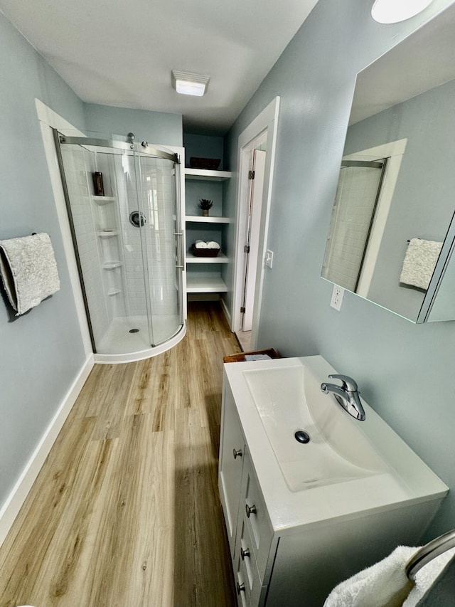 30 Mill St, Harrington, ME 04643 - full bath with a shower stall, wood finished floors, vanity, and baseboards
