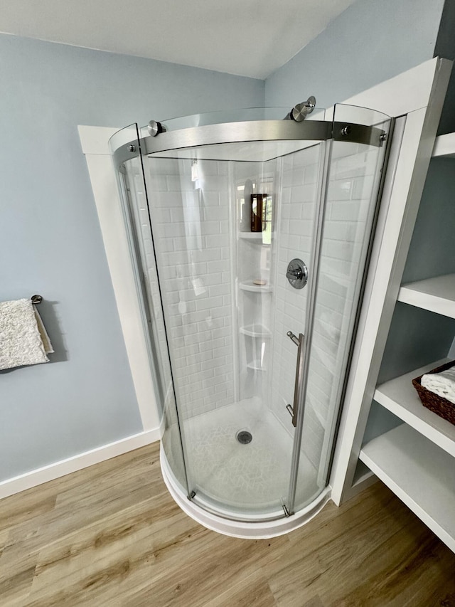 30 Mill St, Harrington, ME 04643 - bathroom featuring wood finished floors, a shower stall, and baseboards