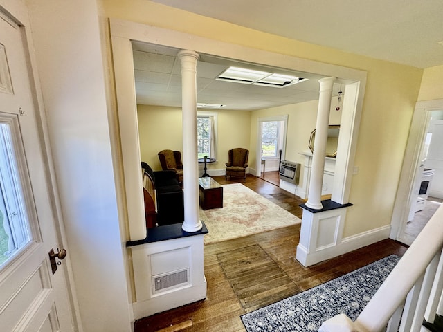 30 Mill St, Harrington, ME 04643 - foyer featuring dark wood-type flooring, ornate columns, heating unit, a drop ceiling, and baseboards