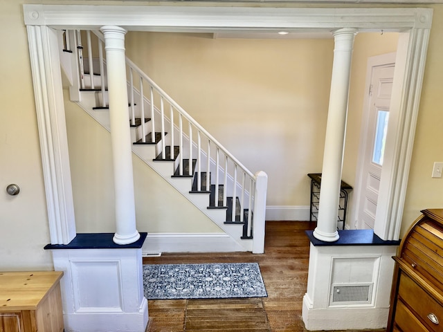 30 Mill St, Harrington, ME 04643 - stairway with wood finished floors, baseboards, and ornate columns