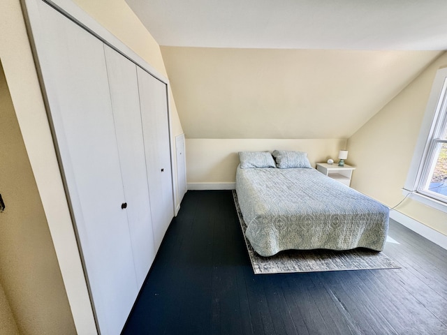 30 Mill St, Harrington, ME 04643 - bedroom with dark wood-type flooring, baseboards, lofted ceiling, and a closet