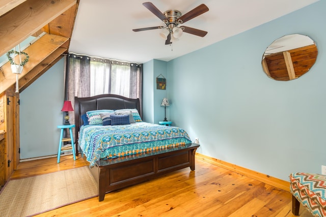 bedroom with wood-type flooring, baseboards, and ceiling fan