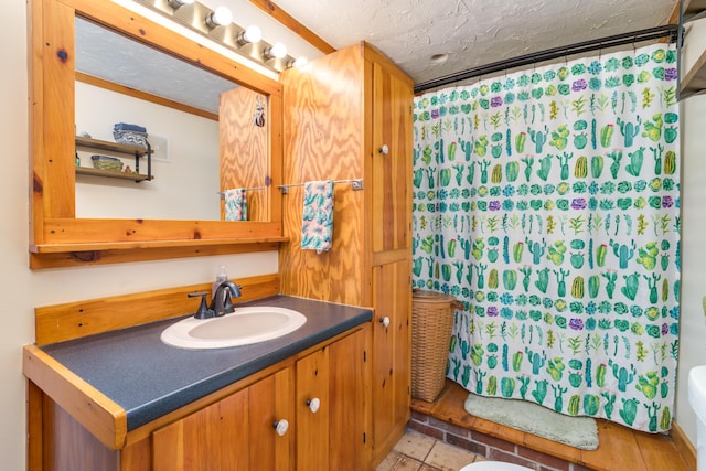 bathroom with vanity, a textured ceiling, and a shower with shower curtain