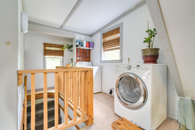 washroom featuring carpet flooring, separate washer and dryer, laundry area, and a wealth of natural light
