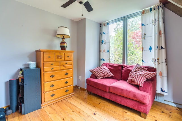 sitting room featuring light wood-style flooring and ceiling fan