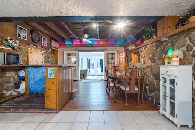 tiled dining room featuring a ceiling fan
