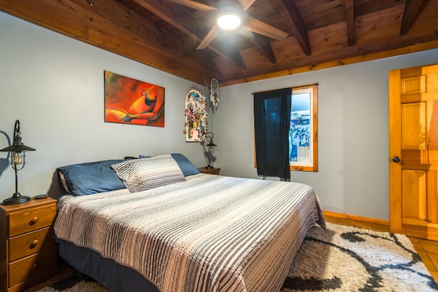 bedroom featuring vaulted ceiling with beams, baseboards, wood ceiling, and tile patterned flooring