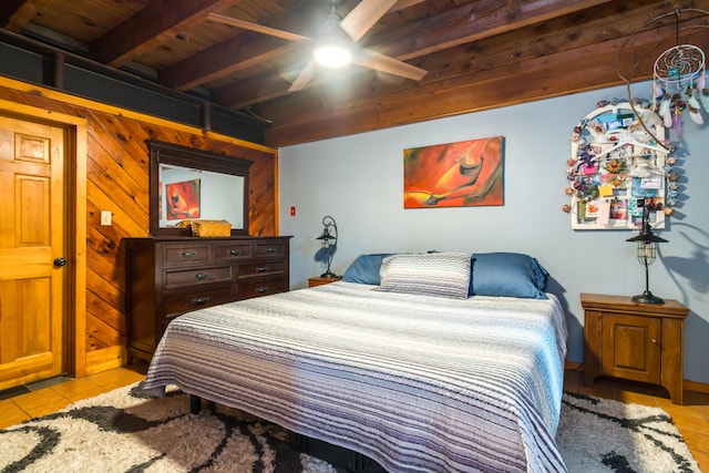 bedroom with a ceiling fan, light tile patterned floors, beam ceiling, and wooden ceiling