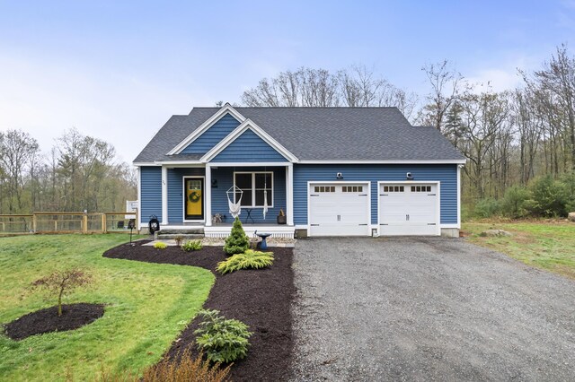 29 Hawks Nest Ln, Wells, ME 04090 - view of front of property with an attached garage, a porch, gravel driveway, and roof with shingles
