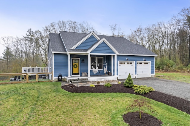 29 Hawks Nest Ln, Wells, ME 04090 - view of front of home with a garage, a porch, driveway, a front yard, and a shingled roof