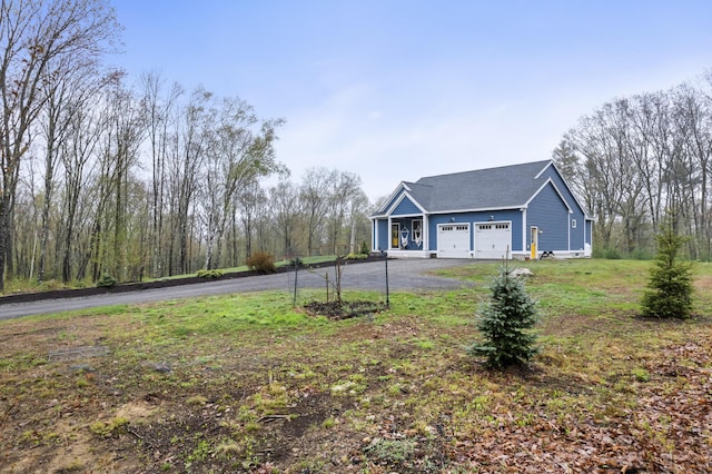 29 Hawks Nest Ln, Wells, ME 04090 - view of front of house with asphalt driveway, a garage, and a front yard