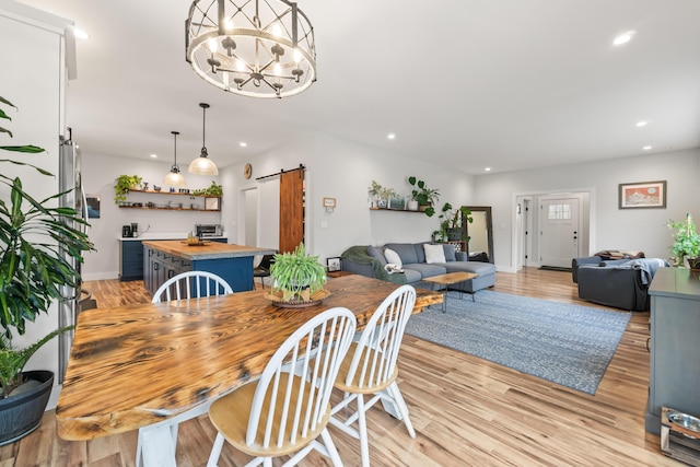 29 Hawks Nest Ln, Wells, ME 04090 - dining area with a barn door, recessed lighting, light wood finished floors, baseboards, and a chandelier
