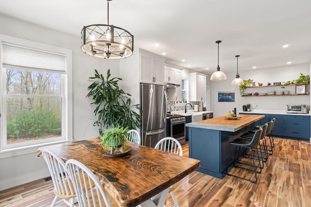 29 Hawks Nest Ln, Wells, ME 04090 - dining area featuring light wood finished floors, a chandelier, recessed lighting, and baseboards