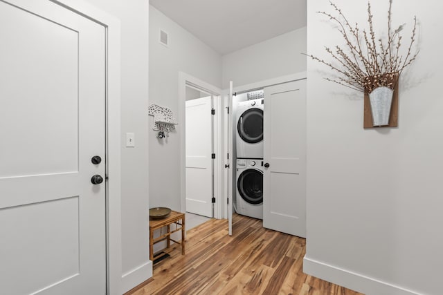 29 Hawks Nest Ln, Wells, ME 04090 - laundry area with stacked washer and clothes dryer, light wood-style floors, and baseboards