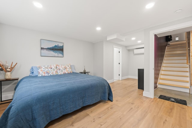 29 Hawks Nest Ln, Wells, ME 04090 - bedroom with light wood-type flooring, recessed lighting, baseboards, and a wall mounted air conditioner