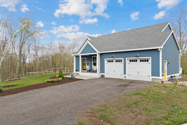 29 Hawks Nest Ln, Wells, ME 04090 - view of front of property with a garage, roof with shingles, asphalt driveway, and a porch