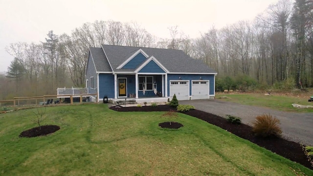 29 Hawks Nest Ln, Wells, ME 04090 - view of front of home with driveway, an attached garage, a front lawn, and a porch