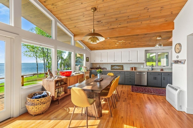 1588 Turtle Head Rd, Islesboro, ME 04848 - dining room with a water view, light wood-type flooring, high vaulted ceiling, and wooden ceiling with exposed beams