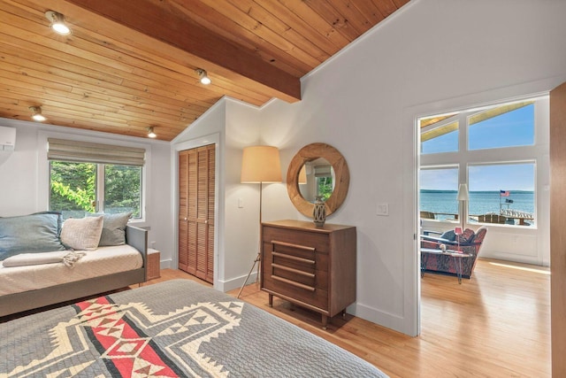 1588 Turtle Head Rd, Islesboro, ME 04848 - living room with vaulted ceiling, light wood-style flooring, baseboards, a water view, and wooden ceiling