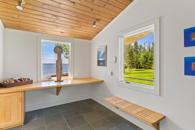 1588 Turtle Head Rd, Islesboro, ME 04848 - unfurnished dining area with wood ceiling, healthy amount of natural light, dark tile patterned floors, and crown molding