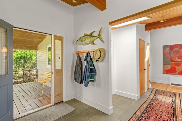 1588 Turtle Head Rd, Islesboro, ME 04848 - hall with tile patterned flooring, baseboards, and wooden ceiling with exposed beams