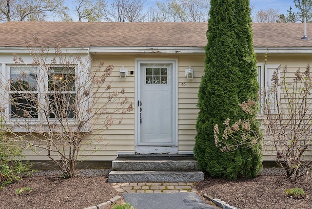 48 Woodside Dr, Kennebunk, ME 04043 - view of exterior entry with roof with shingles