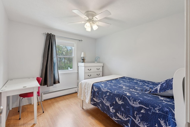 48 Woodside Dr, Kennebunk, ME 04043 - bedroom with a baseboard heating unit, wood finished floors, and a ceiling fan