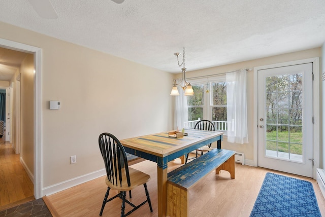 48 Woodside Dr, Kennebunk, ME 04043 - dining room featuring plenty of natural light, a textured ceiling, baseboards, and light wood finished floors