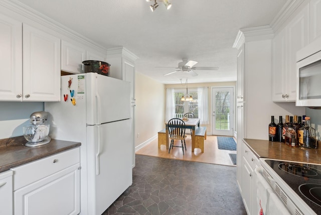 48 Woodside Dr, Kennebunk, ME 04043 - kitchen featuring dark countertops and white cabinetry