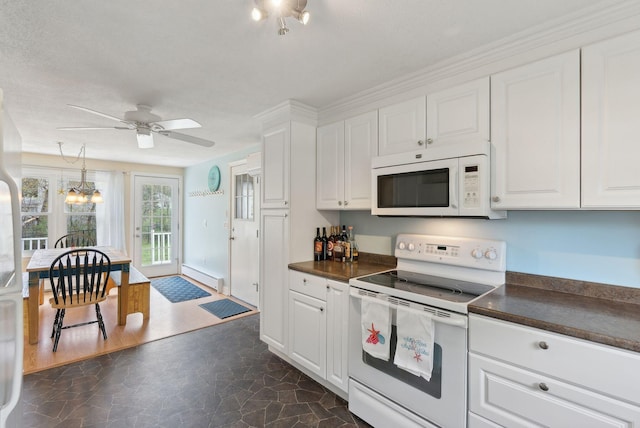 48 Woodside Dr, Kennebunk, ME 04043 - kitchen featuring white appliances, dark countertops, dark stone finish floors, and white cabinets