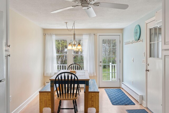 48 Woodside Dr, Kennebunk, ME 04043 - dining space with baseboard heating, wood finished floors, a chandelier, plenty of natural light, and a textured ceiling