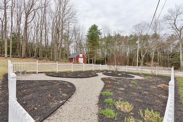 view of yard with fence and an outbuilding