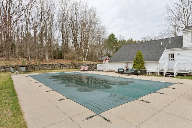 view of pool featuring a patio area, a covered pool, and a deck