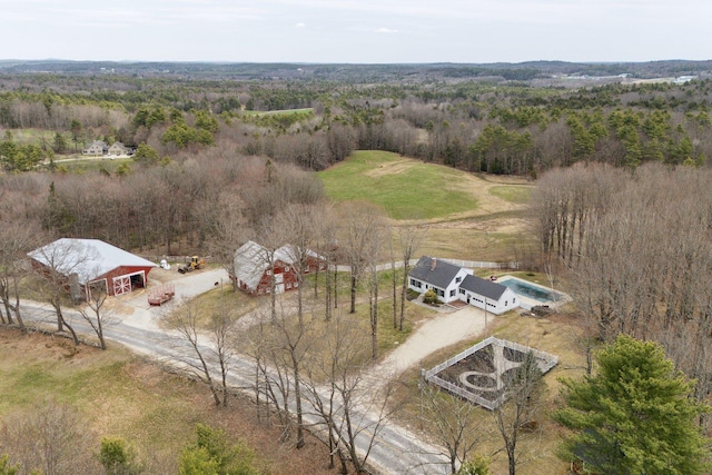 aerial view featuring a forest view and a rural view