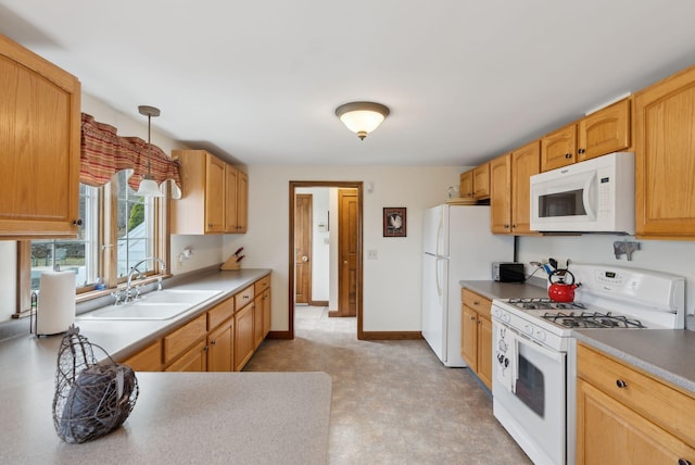 kitchen featuring white appliances, light countertops, a sink, and light floors