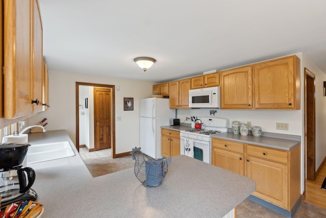 kitchen featuring light colored carpet, a sink, white appliances, light countertops, and a peninsula