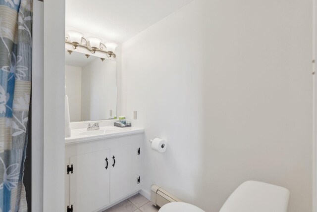 bathroom with toilet, baseboard heating, tile patterned flooring, and vanity