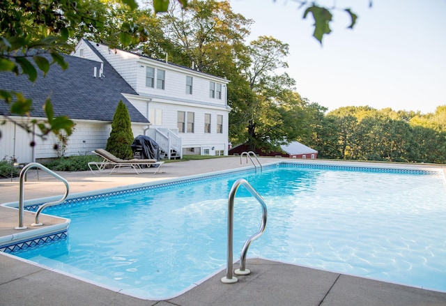 outdoor pool with a patio area