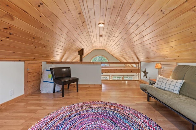 sitting room featuring wood ceiling, wood finished floors, baseboards, lofted ceiling, and wooden walls