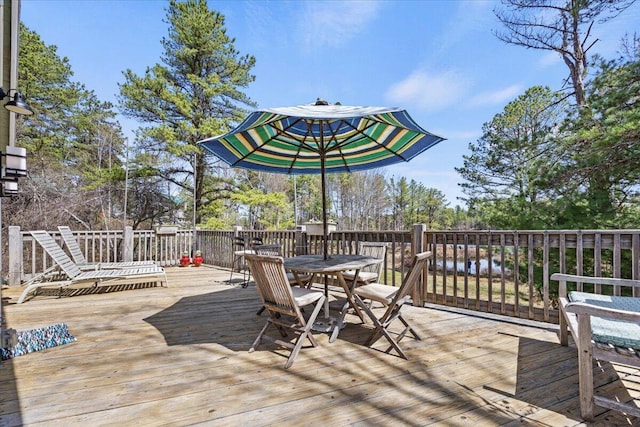 wooden terrace with outdoor dining area