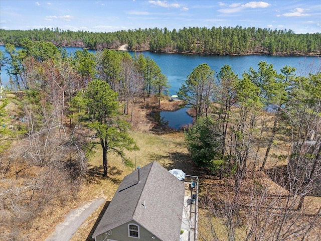 aerial view with a water view and a forest view